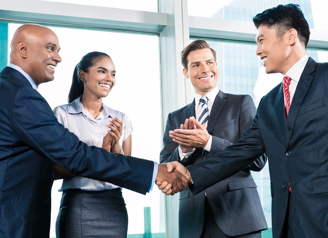 About Our Agency - Friendly Business Professionals Shake Hands After a Meeting at an Office